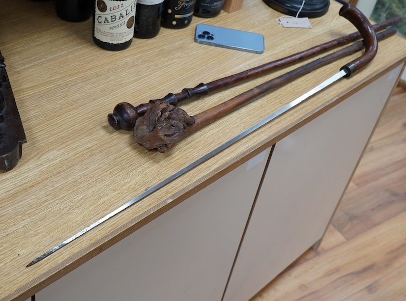 A swordstick and two other walking canes. Condition - fair